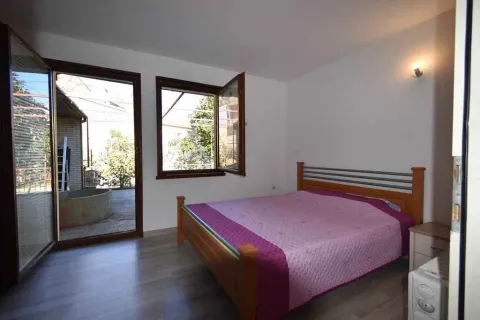 Simple bedroom with a double bed and access to the yard. - image 9