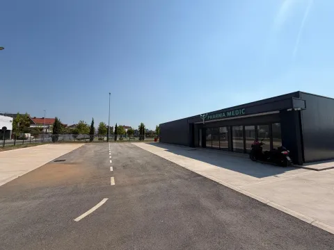Modern single-story commercial building with parking in front. - image 9