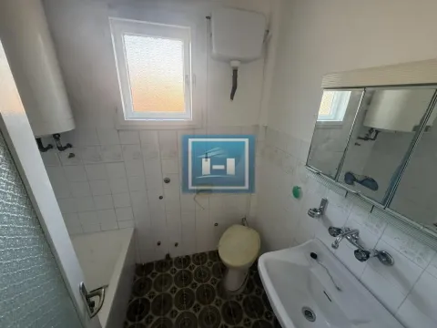 Smaller bathroom with a bathtub, sink, and toilet. - image 8