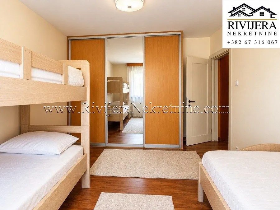Bedroom with bunk beds and a large fitted wardrobe.