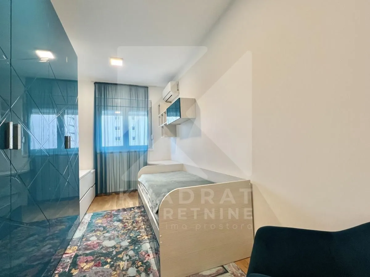 Children's bedroom with a bed, wardrobe and a window.