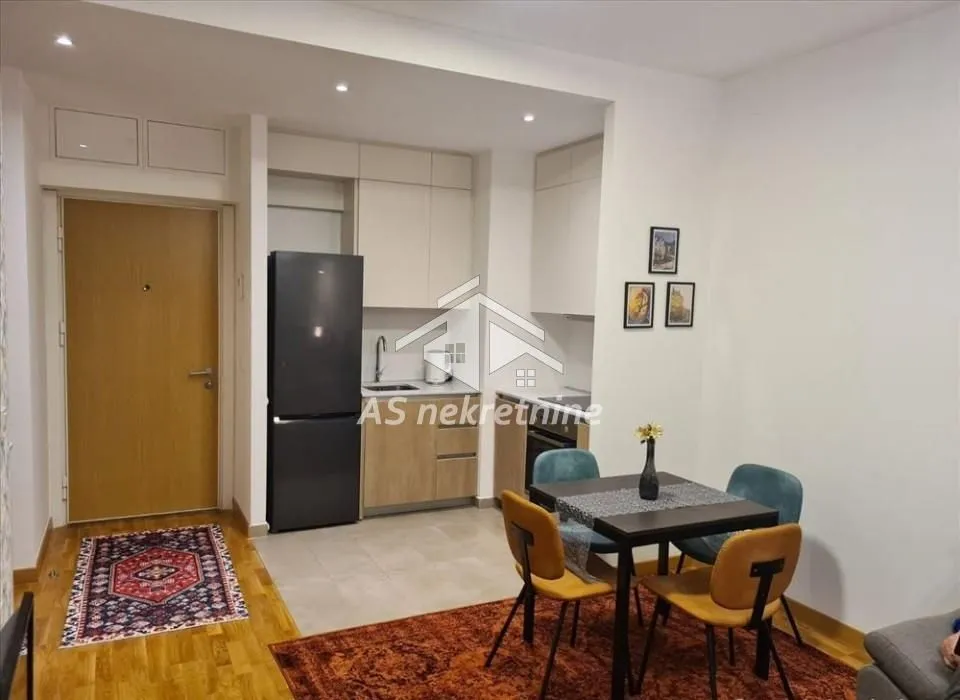 Small kitchen connected to the dining area and entryway.