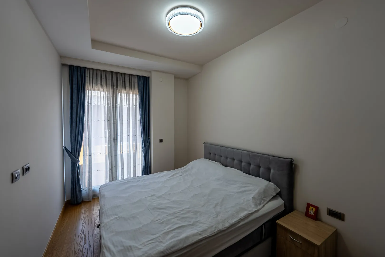 Bedroom with a double bed and balcony doors.
