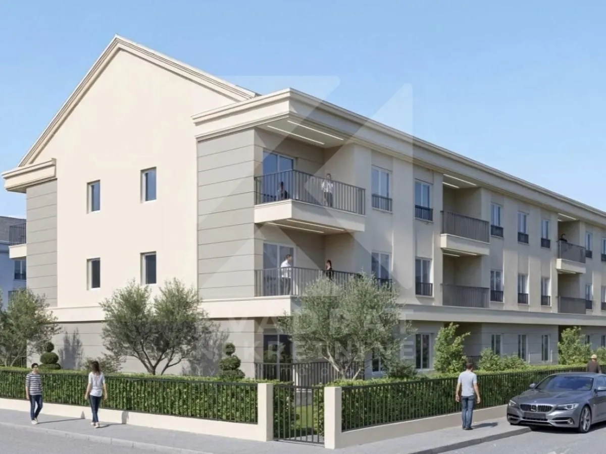 Exterior view of the residential building with a landscaped yard and balconies.
