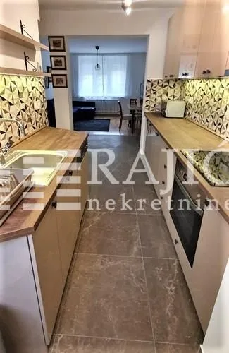 Modern kitchen with built-in appliances and a view of the dining area.
