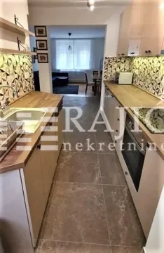 Modern kitchen with built-in appliances and a view of the dining area. - image 5