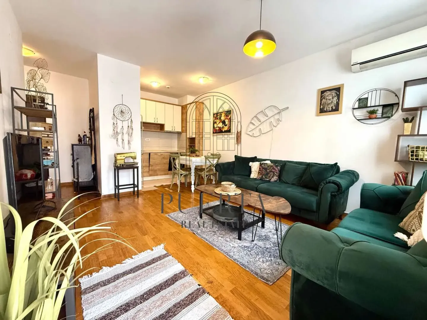 Living room with sofa and dining area in the background.