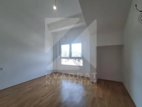 Empty room with hardwood flooring and a single window. - image 5