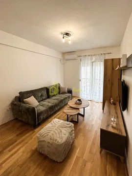Living room with a sofa, coffee tables, and wooden furniture. - image 7