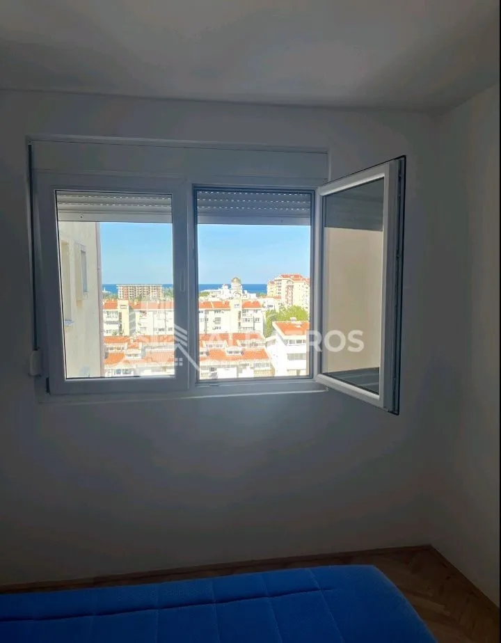 View of the city and sea through the bedroom window.