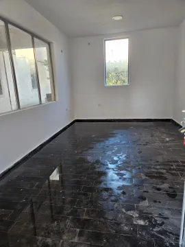 Empty room with dark ceramic floor tiles and large windows. - image 3