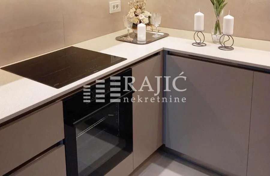 Modern kitchen with built-in hob and oven.
