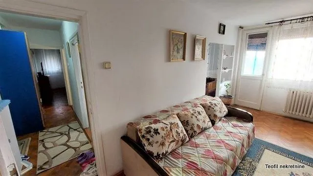 Living room with a sofa and view of the hallway.