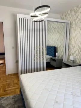 Furnished bedroom with a large wardrobe and a double bed. - image 7