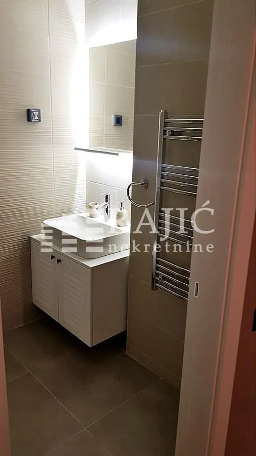 Modern bathroom with sink and shower cabin.