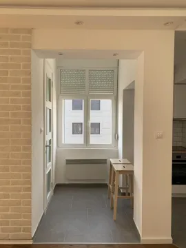 Glazed balcony space with a window and bar stools. - image 8