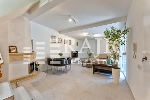 Spacious living room with a fireplace and dining area.
