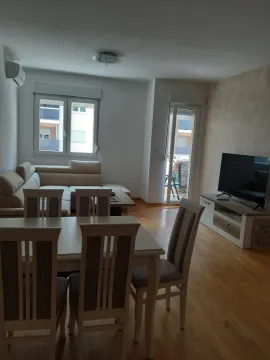Bright living room featuring a dining table and corner sofa. - image 8