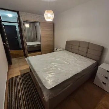 Furnished bedroom with a double bed, wardrobe, and nightstand. - image 3