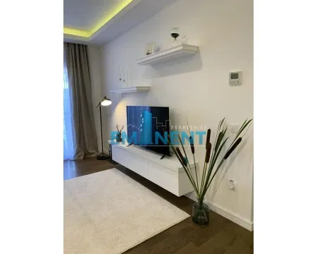 Living room with a TV unit, shelves, and decorative elements. - image 6