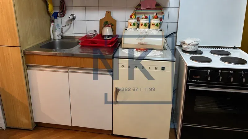 Smaller kitchen with a sink, refrigerator, and stove.