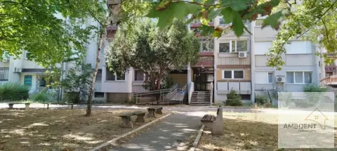 View of the building facade with a landscaped courtyard and greenery. - image 25