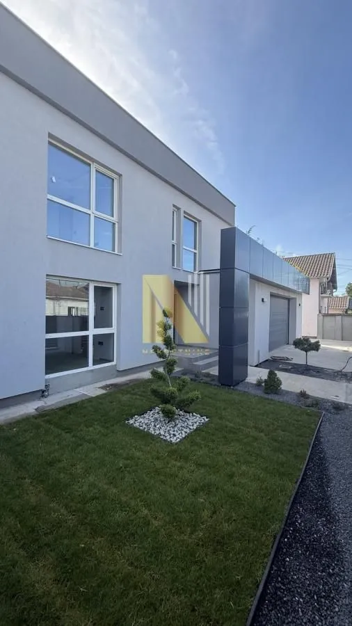 Modern two-story house with a landscaped yard and lawn.