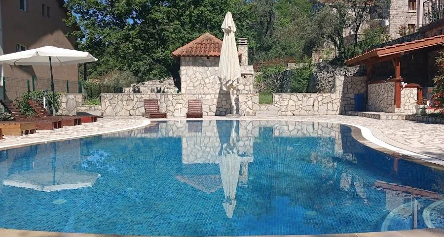 Swimming pool with a tiled patio and sun loungers in the property's courtyard.