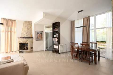 Spacious living room with a fireplace and dining area. - image 8