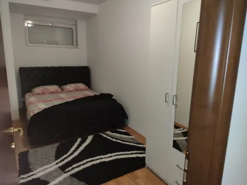 A bedroom featuring a double bed, a white wardrobe, and a black and white rug. - image 27