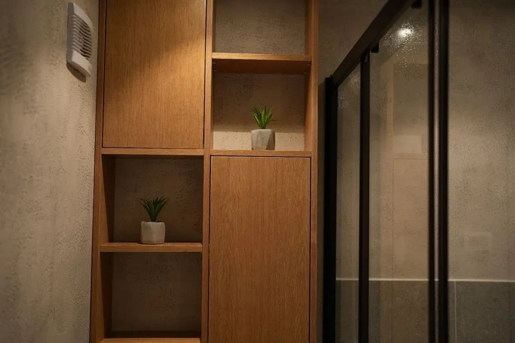 Modern wooden shelves and a shower cabin in the bathroom.