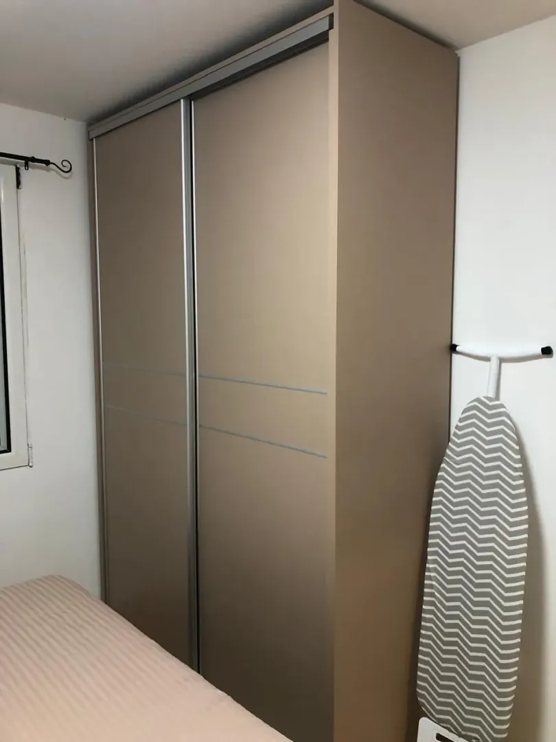 A view of a large sliding door wardrobe in the bedroom.