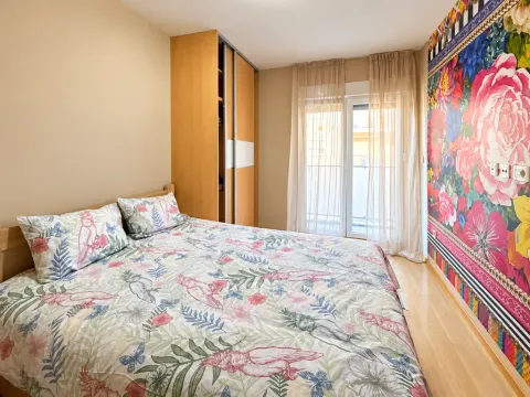 Bedroom with a double bed, built-in wardrobe, and balcony doors. - image 5