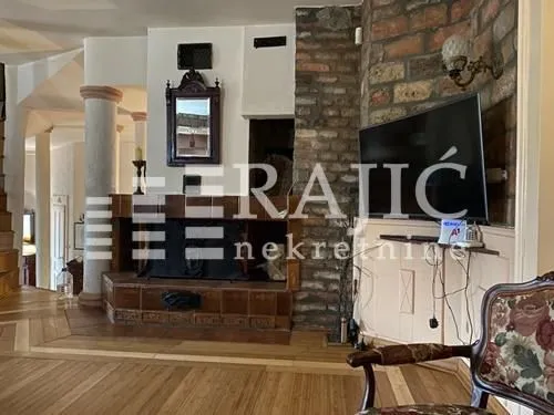 Living room with a fireplace and wooden floor.