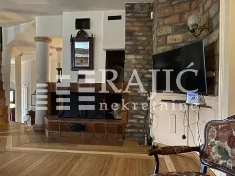 Living room with a fireplace and wooden floor. - image 6