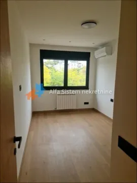 Empty room with hardwood floors, a window, and an air conditioning unit. - image 5