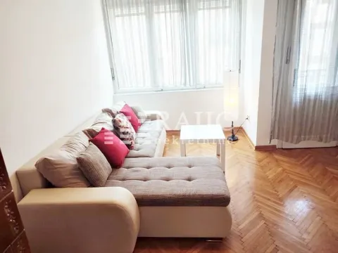 Bright living room with a corner sofa and parquet flooring. - image 3