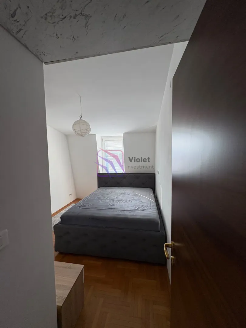 Bedroom with a double bed and parquet flooring.