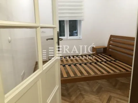 Bedroom with a wooden bed and parquet flooring. - image 5