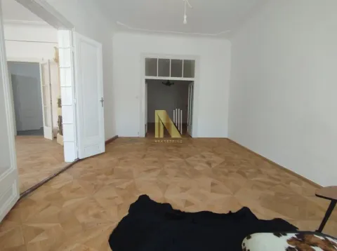 Empty living room with wooden parquet flooring and white walls. - image 11