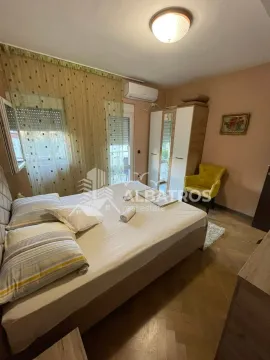 Furnished bedroom with a double bed, wardrobe, and a yellow armchair. - image 7
