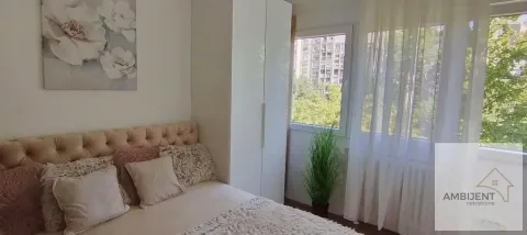Furnished bedroom with a double bed, wardrobe, and a window with a view. - image 12