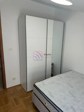 Furnished bedroom with a white wardrobe and bed. - image 14