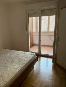 Bedroom with a bed and access to the terrace. - image 3