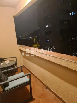 Furnished terrace with seating furniture and a view of the city at night. - image 9