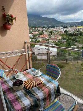Namješten balkon sa stolom, stolicama i lijepim pogledom na prirodu i grad. - image 10
