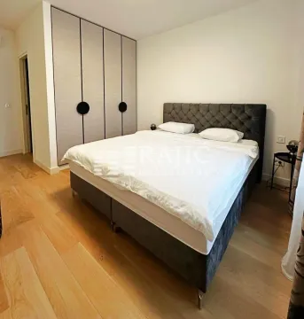 Modern bedroom with a double bed and built-in wardrobe. - image 2