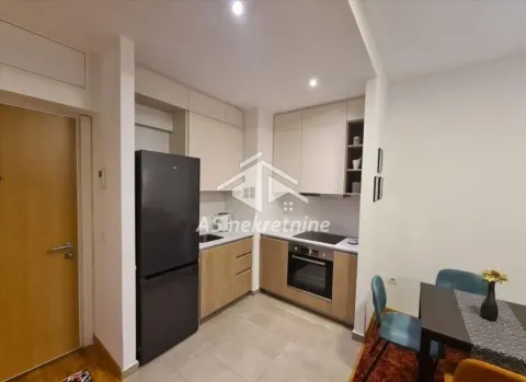 Modern kitchen with built-in units and a dining table. - image 6
