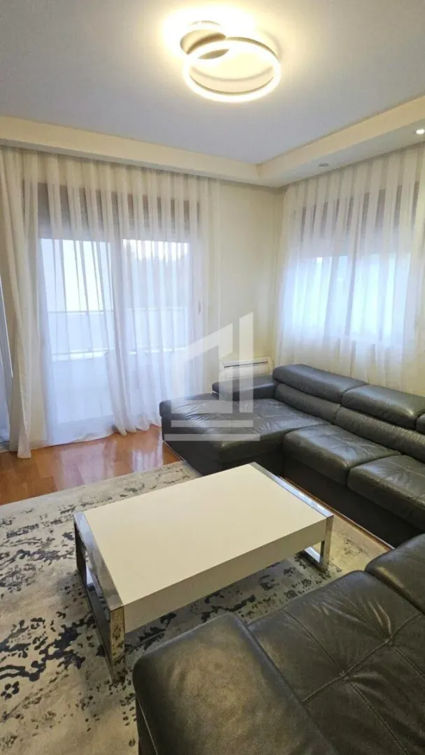 Living room with a sofa set and a white coffee table.