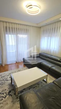 Living room with a sofa set and a white coffee table. - image 2